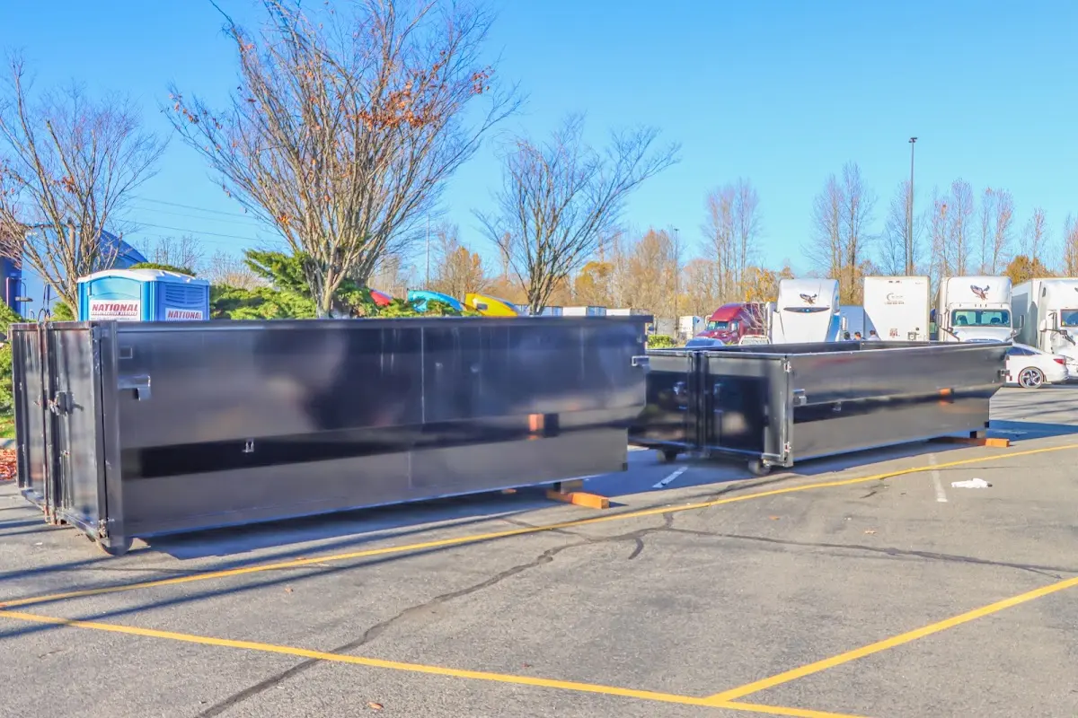 Professional dumpster rental service with roll-off container on residential driveway in Key Biscayne